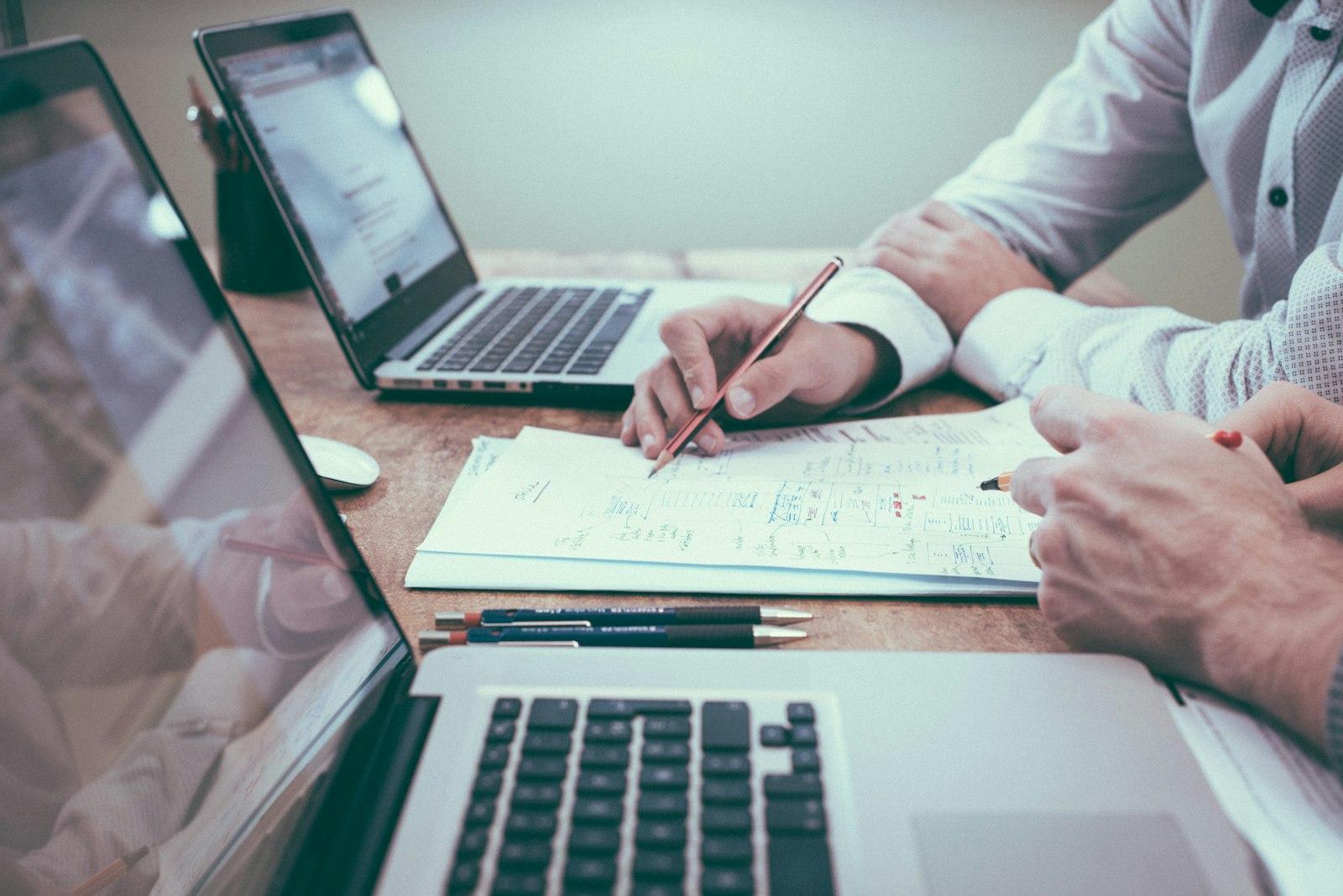 Two advisors reviewing financial reports together